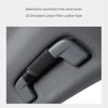A close-up view of a gray car roof handle cover made of 3D simulated carbon fiber leather style material.
