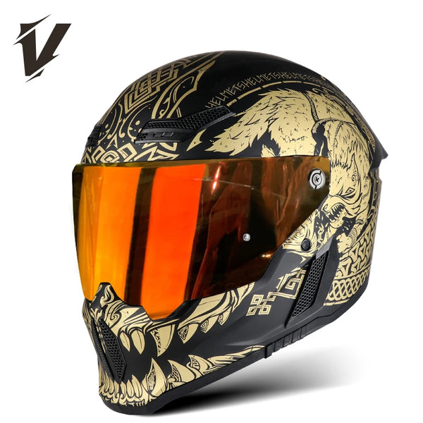 A black full face motorcycle helmet with a gold and black graphic design and an orange visor.