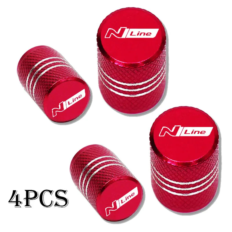 Set of four red aluminum tire valve caps with a textured finish and N Line branding