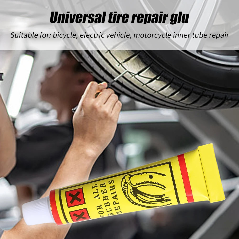 Un kit de colle pour réparation de tube est utilisé pour réparer un pneu, avec un pneu visible en arrière-plan.