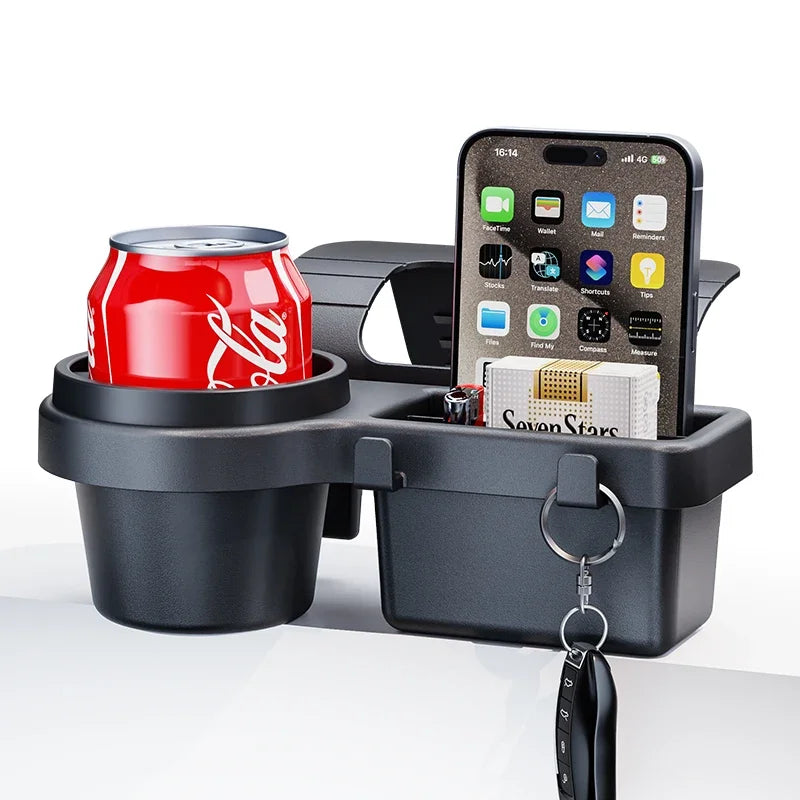 A black car door storage organizer features a cup holder and a phone mount, holding a can and a smartphone.