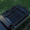 A close-up view of a black heavy-duty roof bar or cargo basket installed on a vehicle, designed for a seamless fit.
