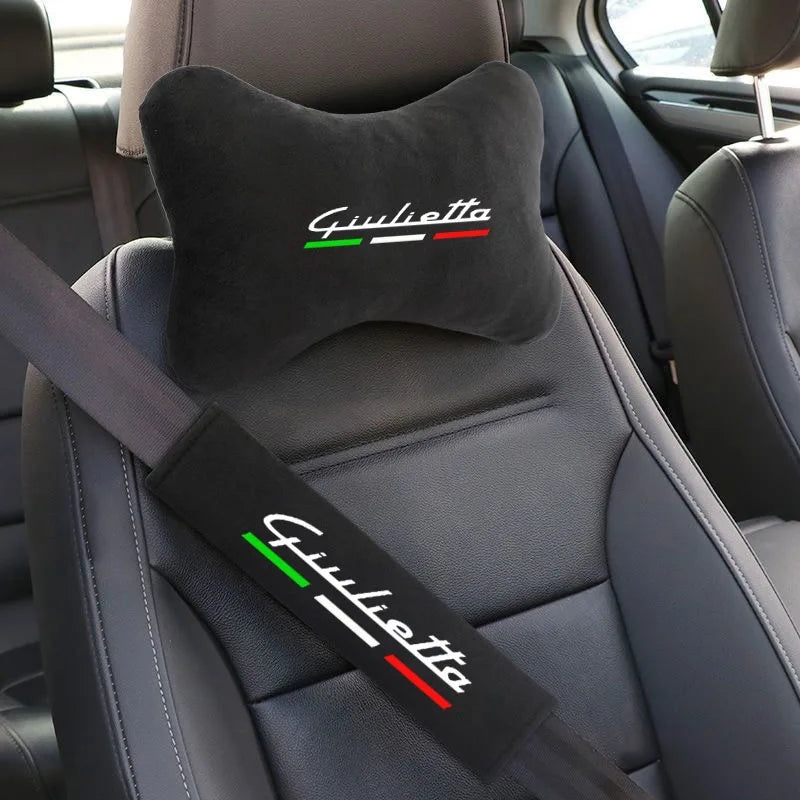 A black shoulder cushion with the name Giulietta embroidered in green and red on a car seat belt.