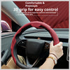 A hand grips a red three-segment grip for easy control on a steering wheel.