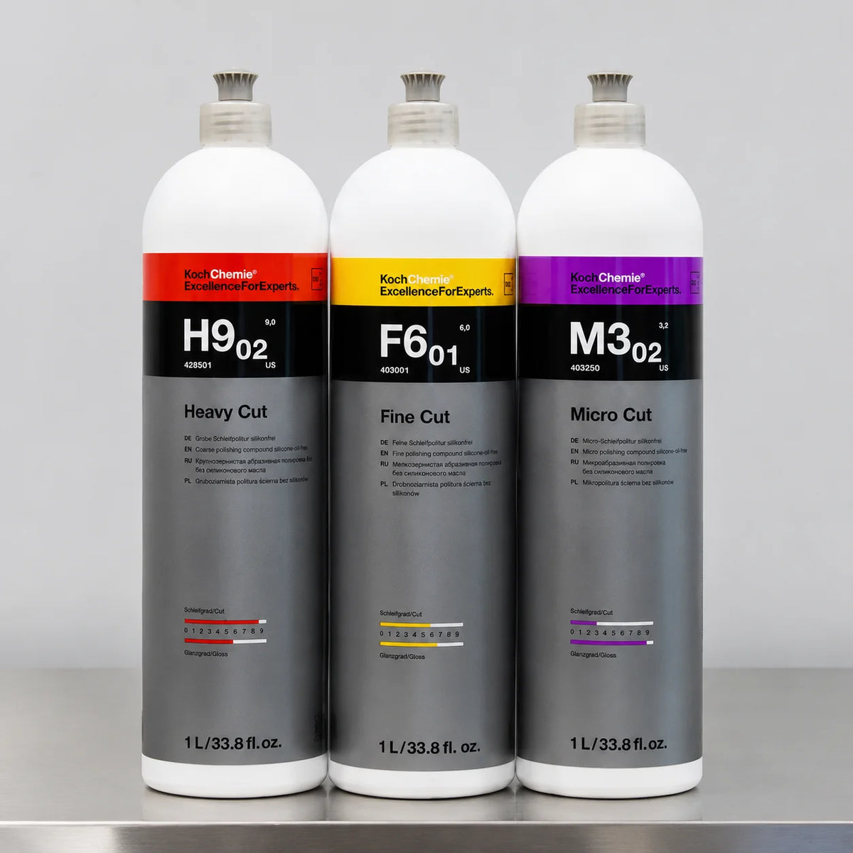 Three white aerosol cans of Koch Chemie paint correction compound, labeled Heavy Cut, Fine Cut, and Micro Cut.