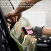 A hand uses a felt squeegee tool to remove bubbles and scratches from a clear vinyl film.