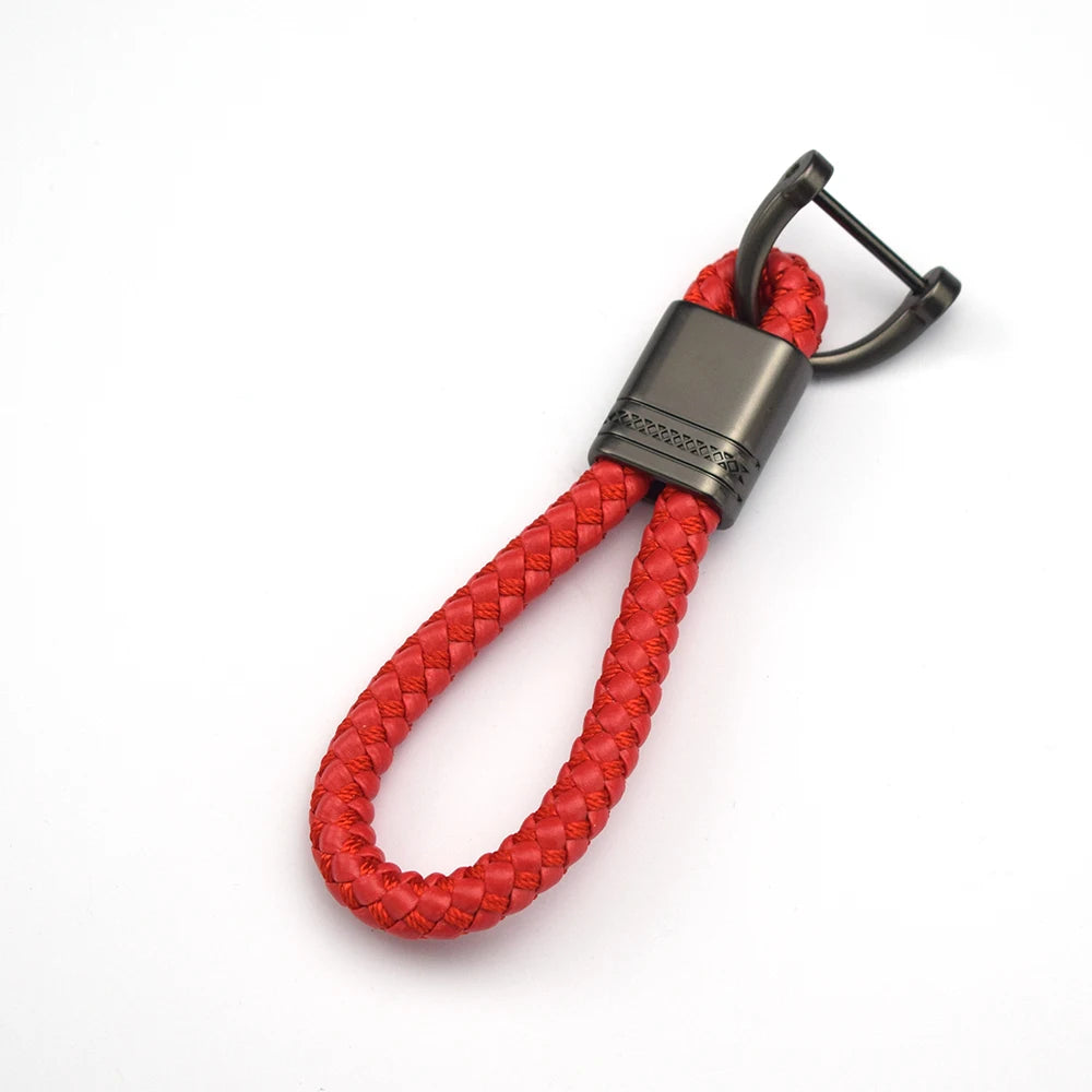A red braided leather key case cover with a metal clasp and loop.