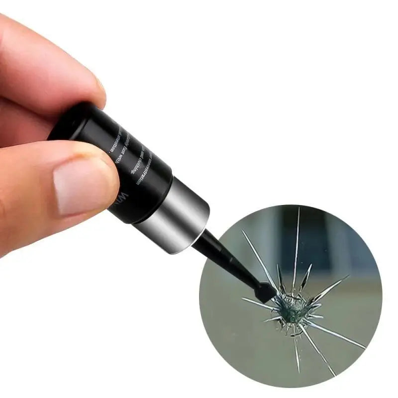 A hand holds a black glass crack repair kit with a pointed applicator, showing the tool's tip.