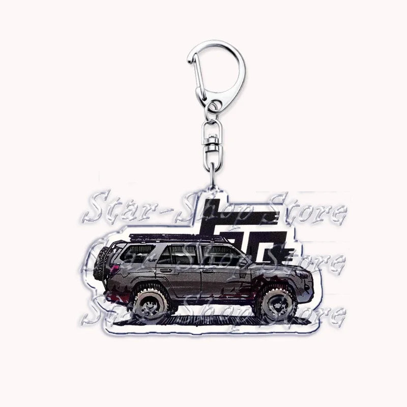 Silver acrylic keychain featuring a silhouette of a dark off-road truck.