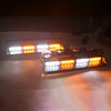 A close-up view of emergency dash strobe lights mounted on a surface, showing bright amber and white illumination.