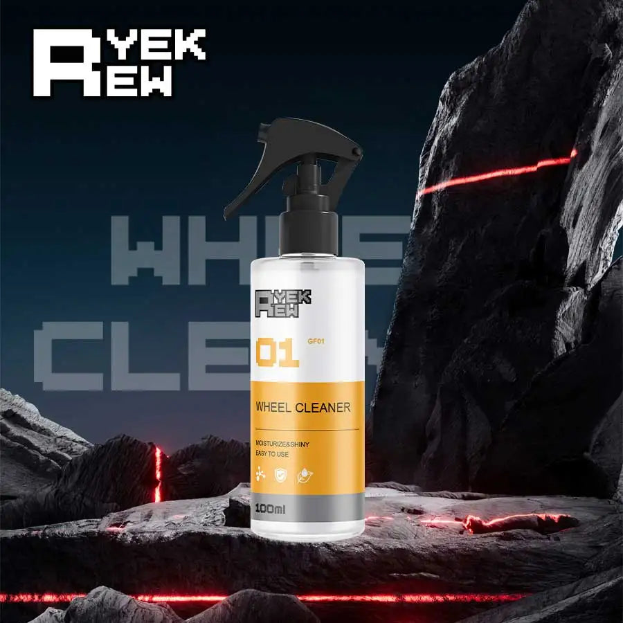A bottle of YEK REW Wheel Cleaner with a black pump dispenser is shown against a dark, rocky background.