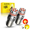 A pair of LED light bulbs for automotive use shown next to its packaging and a disassembled bulb.