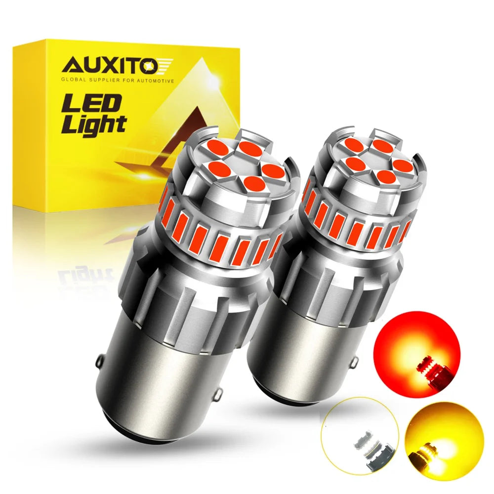 A pair of LED light bulbs for automotive use shown next to its packaging and a disassembled bulb.