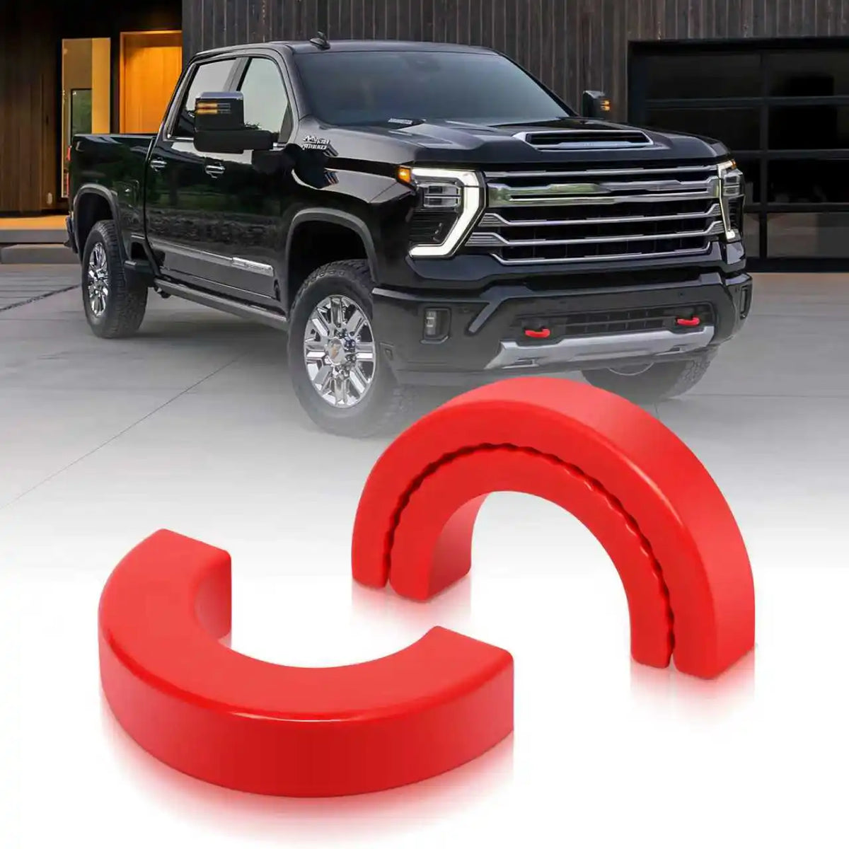 Red silicone tow hitch covers shown next to a black pickup truck.