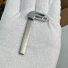 A close-up of a silver aftermarket remote key for Chevrolet trucks and SUVs held in a person's hand.