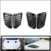 Black carbon fiber car hood scoop vent trim pieces.