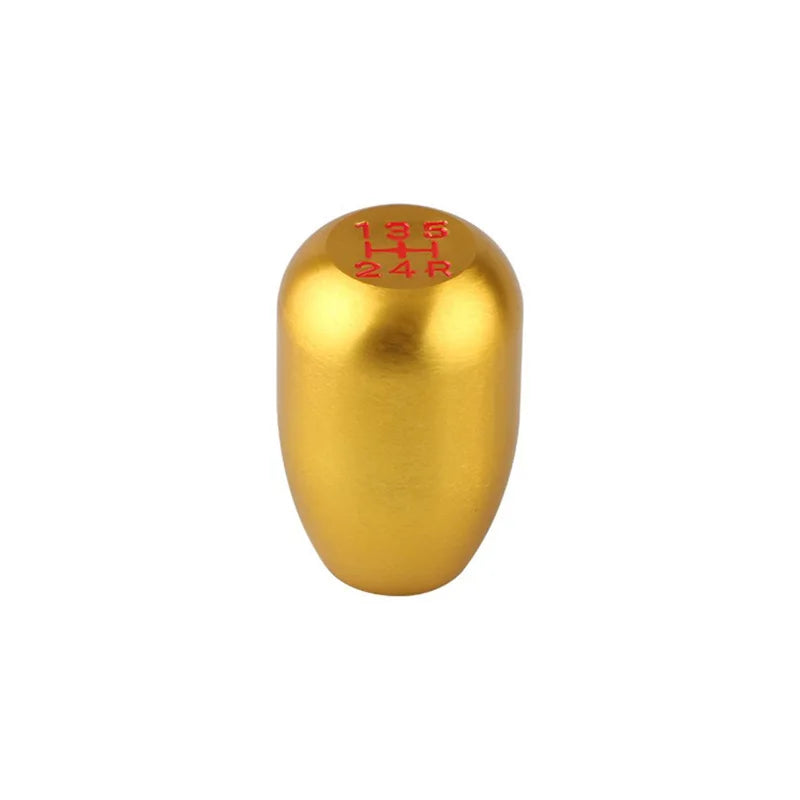 A golden aluminum gear shift knob with markings 135 H and 24 R.