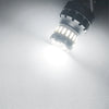 Close-up view of an LED brake and reverse light bulb emitting a bright white illumination.