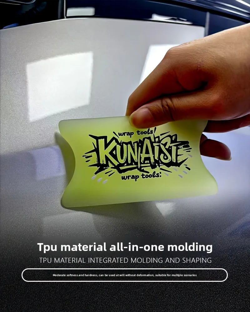 A hand holds a translucent yellow TPU material tool for wrapping and molding automotive film.