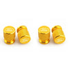 Four gold-colored aluminum car wheel valve caps shown in a row.