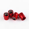 A set of red metal tire valve caps with black tops featuring the GTI logo.