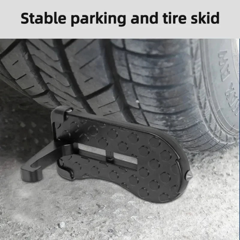 A black foldable car door step pedal and roof access hook is shown resting on a concrete surface.