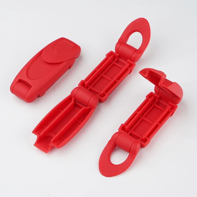 A bright red comfort-adjustable seat belt clip is shown in various forms, including a flat piece and an elongated clip.