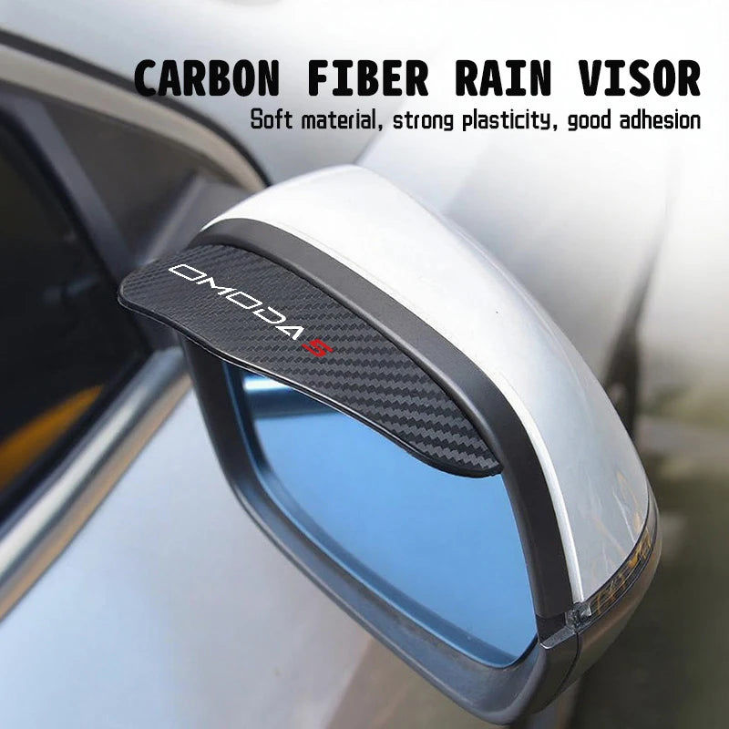 A carbon fiber rain visor is installed on a car's rearview mirror, showing the clear interior view.