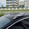 A close-up of a black car roof decorated with a silver dragon horn accessory.
