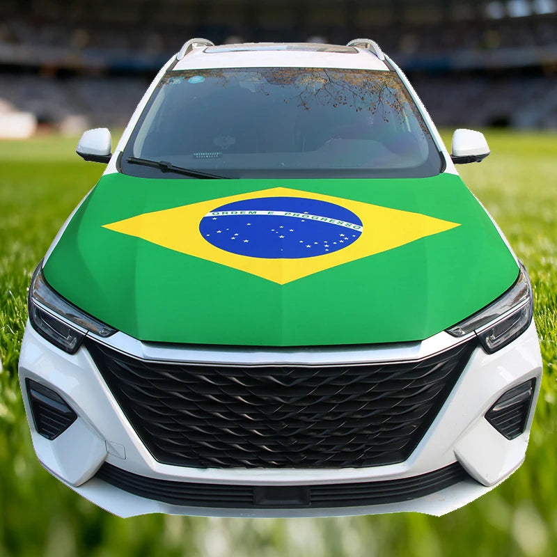 A white car hood decorated with a large Brazilian flag featuring green, yellow, and blue colors.