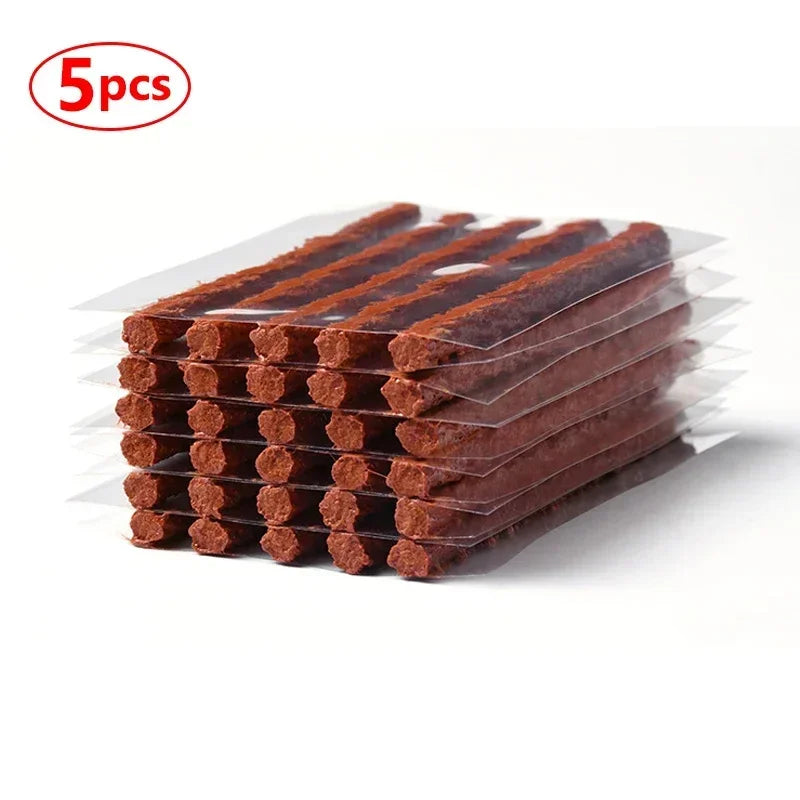 Five pieces of brown natural rubber tire repair strips packaged in clear plastic.