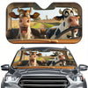 A foldable car windshield sun shade featuring cartoon cows looking out from the vehicle interior.