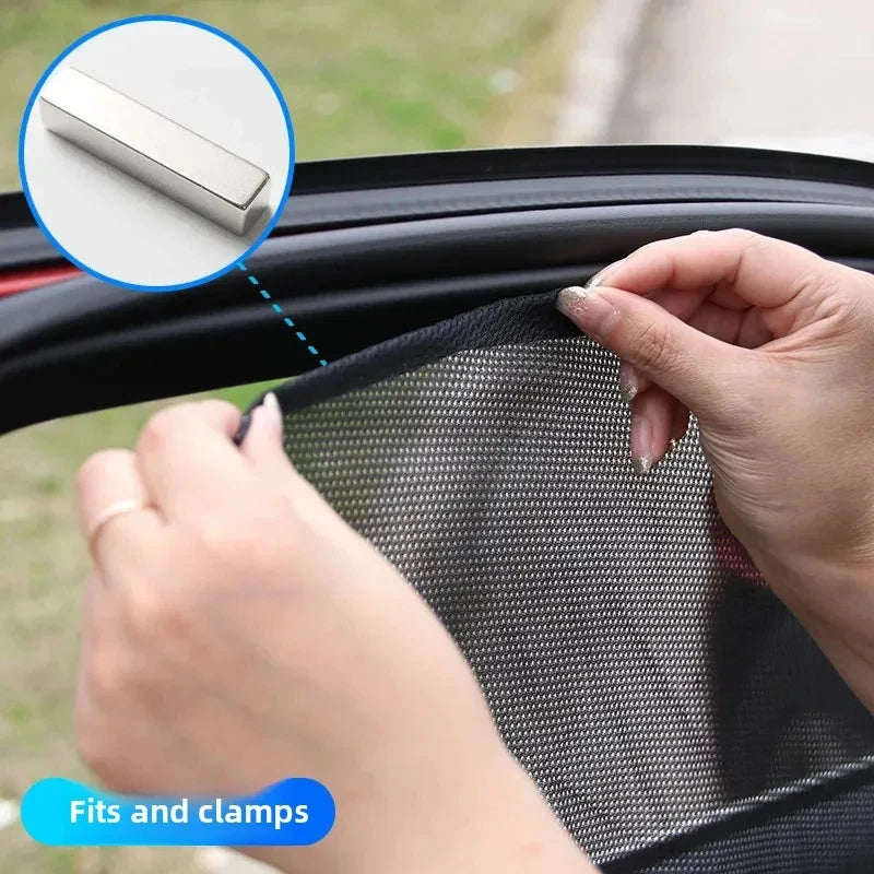 A hand is clamping a magnetic car window sunshade onto a car window frame.