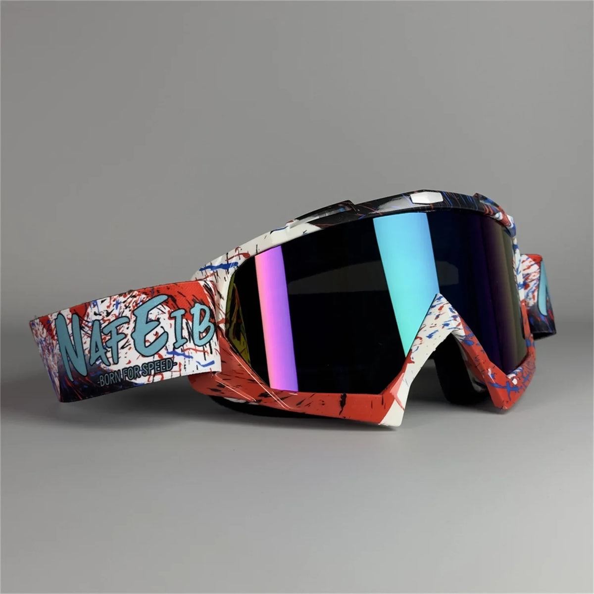 A pair of orange and black motorcycle off-road goggles with a graphic design on the strap.