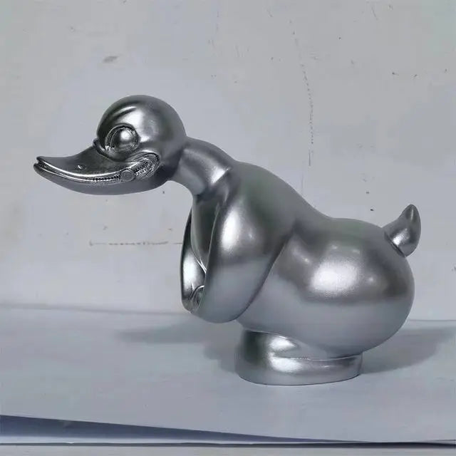 A silver decorative angry duck hood ornament for a car or motorcycle.