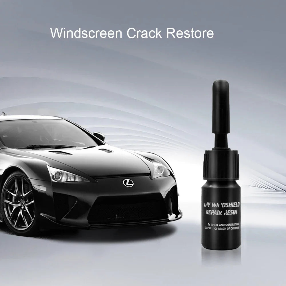 A bottle of Windscreen Crack Restore resin next to a black Lexus sports car.