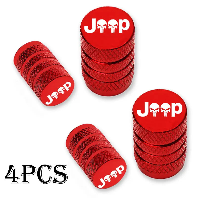 Four red Jeep tire valve caps stacked in a pile.