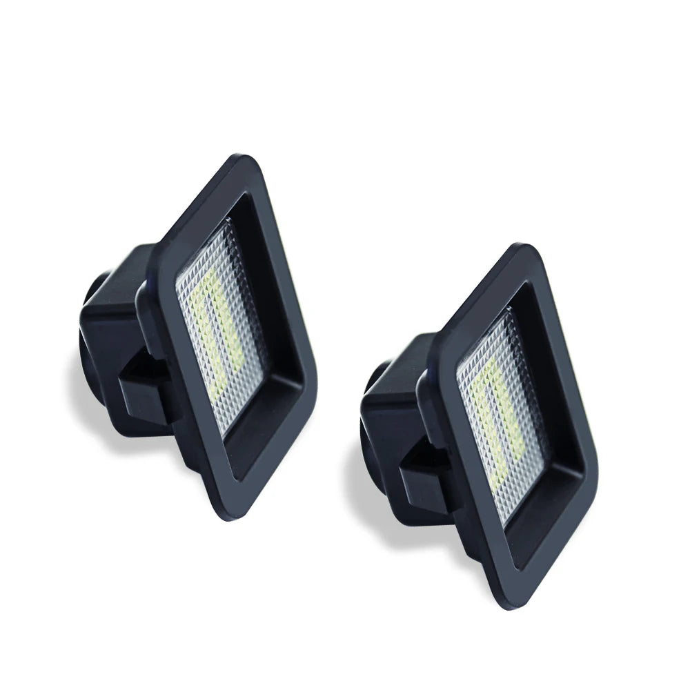 A pair of black LED license plate lights designed for Ford F-150 and Raptor vehicles.