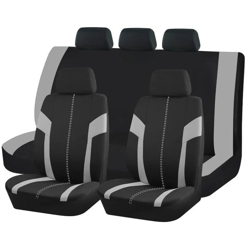 Un ensemble de housses universelles pour sièges de voiture en polyester noir et gris, présentées en rangée.