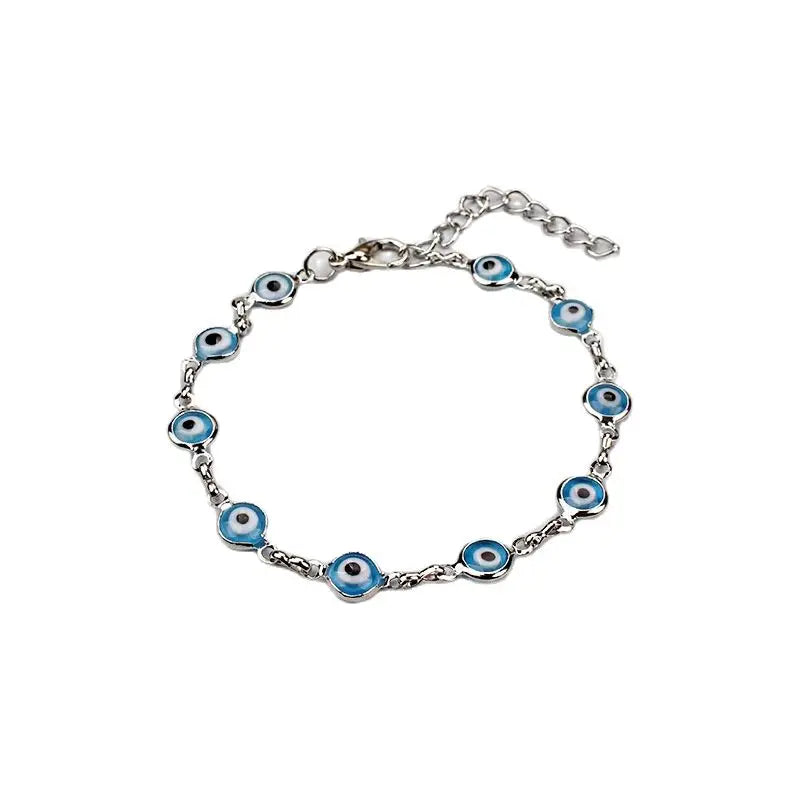Gold plated evil eye charm bracelet featuring an adjustable link chain.