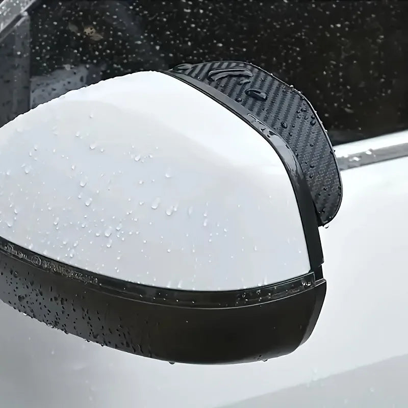 Black anti-fog textured covers placed over a vehicle's rearview mirror, with water droplets visible.