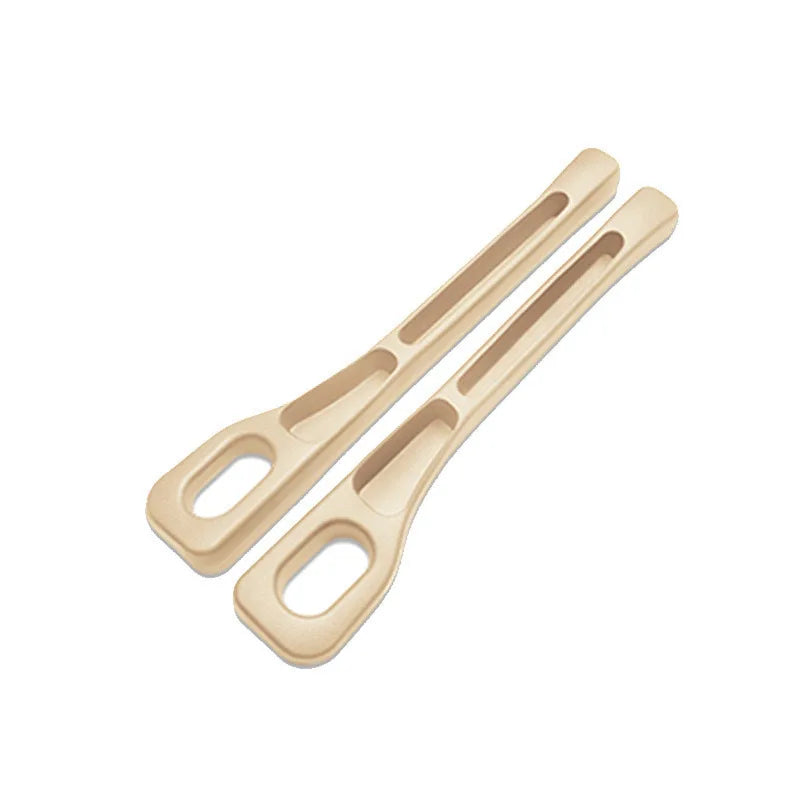 Two elongated, light beige car seat gap plug strips for protection