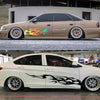 A tan sedan features custom flame racing stripe vinyl decals on the side, parked outdoors.