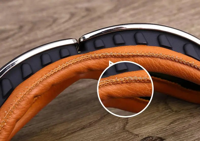 Close-up of retro folding motorcycle windproof glasses with brown leather padding and silver frame.