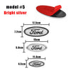 A set of Ford front hood emblem replacements in bright silver and black, showing various sizes.