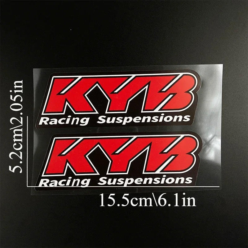Two rectangular decals featuring the KYB Racing Suspensions logo and text on a black background.