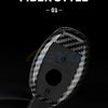 A close-up view of a black carbon fiber style car key cover for Mercedes models.