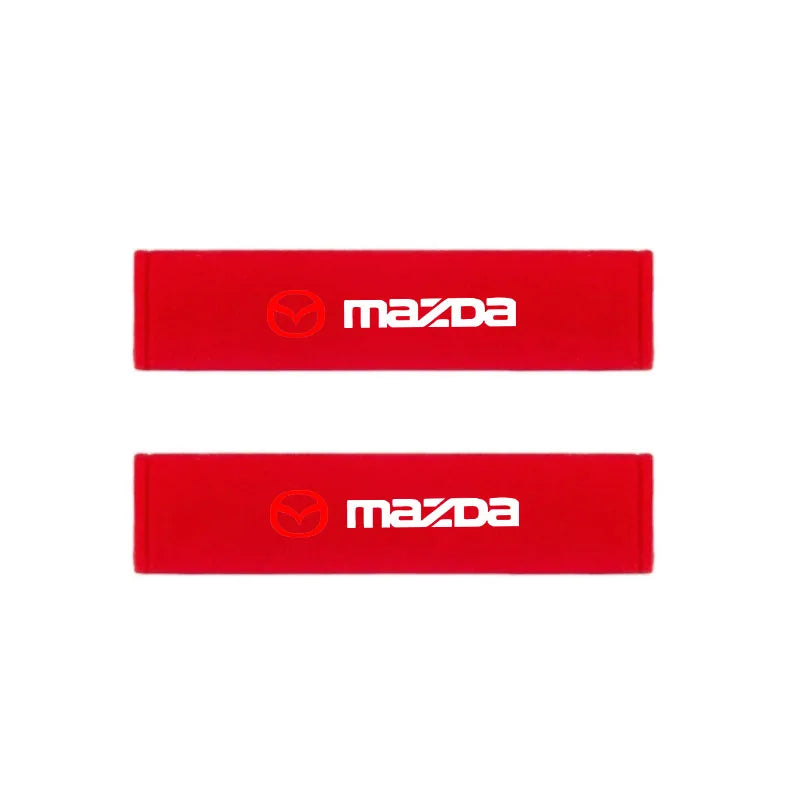 Two red Mazda seat belt shoulder pads displayed side by side.