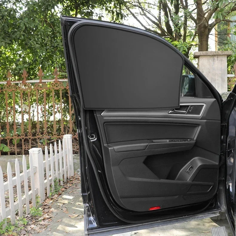 A black car window with a dark gray magnetic sunshade deployed, showing the interior panel.