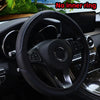 Black embossed leather steering wheel cover with blue stitching shown inside a car